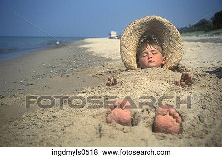 Stock Photo - Buried at the Beach. Fotosearch