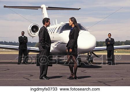 Businessman and Businesswoman Talking Outside Airplane View Large Photo Image Stock Image - Businessman and Businesswoman Talking Outside Airplane. Fotosearch