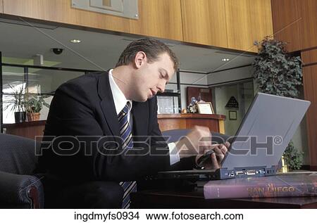 Businessman Using Cell Phone and Laptop View Large Photo Image Picture - Businessman Using Cell Phone and Laptop. Fotosearch