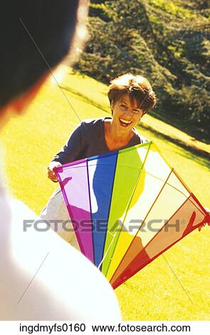 Couple Flying Kite in Park View Large Photo Image Stock Image - Couple Flying Kite in Park. Fotosearch