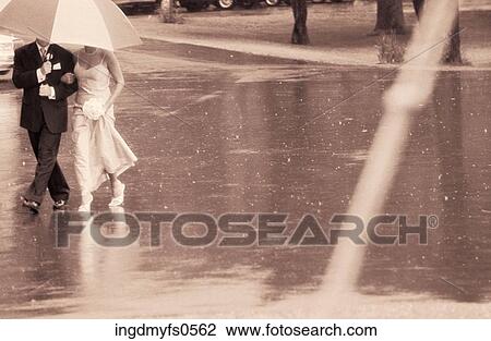 Stock Image - Couple under an Umbrella. Fotosearch
