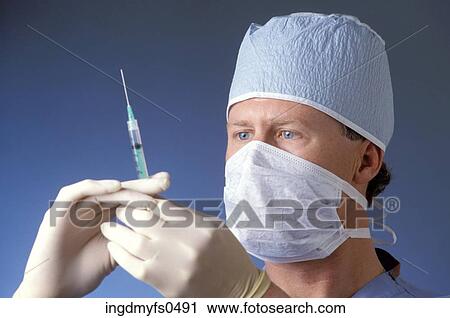 Doctor Tapping the Needle View Large Photo Image Stock Image - Doctor Tapping the Needle. Fotosearch
