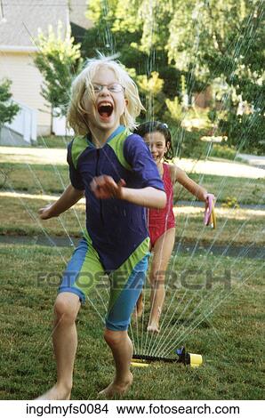 Girls Laughing and Running Through Sprinkler View Large Photo Image Picture - Girls Laughing and Running Through Sprinkler. Fotosearch