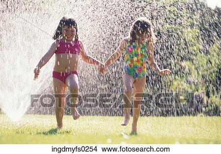 Girls Playing in Sprinkler View Large Photo Image Picture - Girls Playing in Sprinkler. Fotosearch