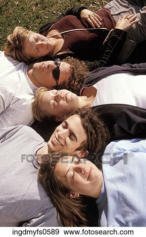 Group of People Lying in the Grass View Large Photo Image Stock Photo - Group of People Lying in the Grass. Fotosearch
