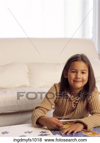 Little Girl Doing a Jigsaw Puzzle View Large Photo Image Stock Photo - Little Girl Doing a Jigsaw Puzzle. Fotosearch