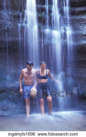 Man and Woman Standing Under a Waterfall View Large Photo Image Stock Photograph - Man and Woman Standing Under a Waterfall. Fotosearch