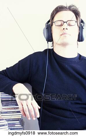 Man Listening to Headphones View Large Photo Image Stock Photo - Man Listening to Headphones. Fotosearch