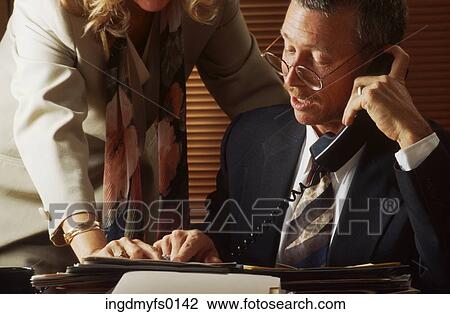Stock Image - Man on the Phone at His Desk. Fotosearch