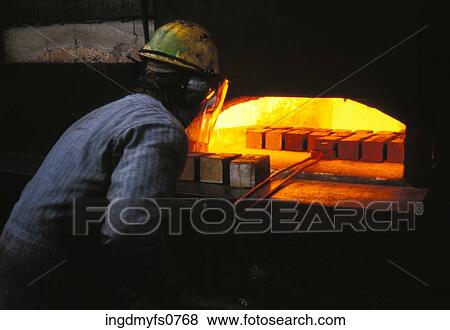 Stock Photo - Man Pulling Bricks Out of Forge. Fotosearch