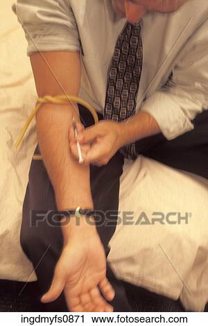 Stock Image - Man Shooting Heroin. Fotosearch