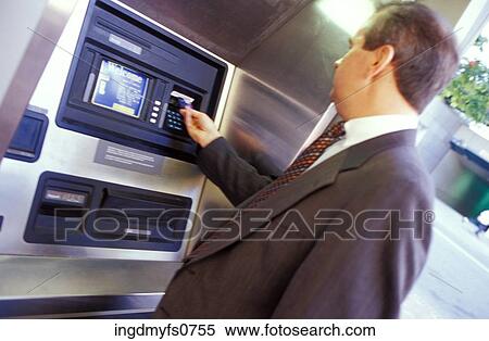 Stock Photography - Man Using an ATM. Fotosearch