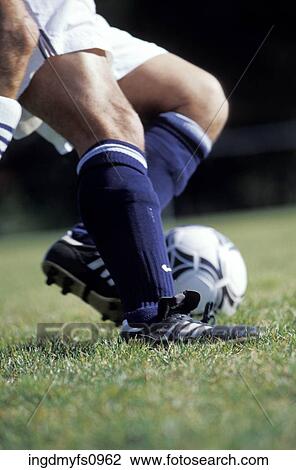 Stock Image - Man's Legs Playing Soccer. Fotosearch