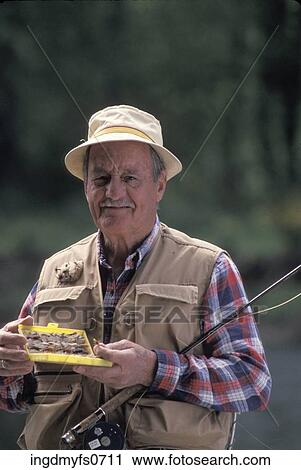 Stock Image - Old Man Fly Fishing. Fotosearch