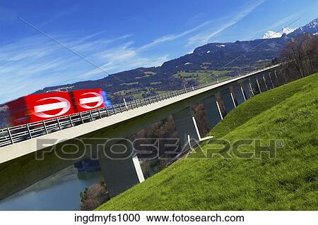 Stock Image - Truck Driving on Long Freeway Bridge. Fotosearch