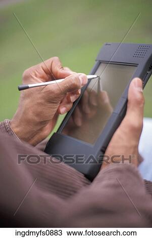 Using a PDA View Large Photo Image Stock Image - Using a PDA. Fotosearch