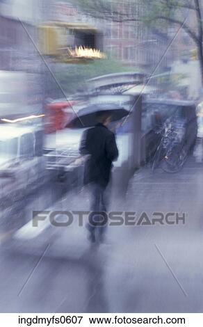 Stock Photo - Walking with an Umbrella. Fotosearch