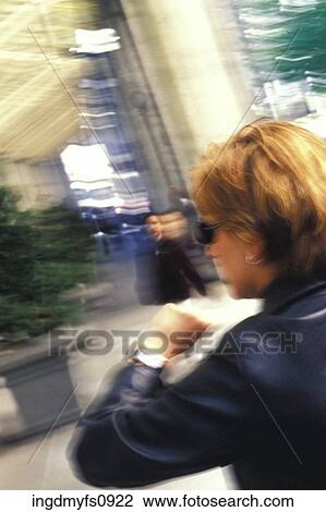 Stock Image - Woman Checking Her Watch. Fotosearch