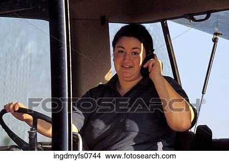 Woman Driving Huge Machine Talking on Cell Phone View Large Photo Image Picture - Woman Driving Huge Machine Talking on Cell Phone. Fotosearch