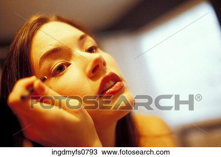 Stock Image - Woman Putting on Eyeliner. Fotosearch