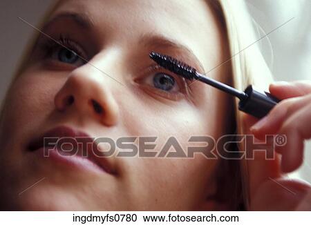 Woman Putting on Mascara View Large Photo Image Stock Image - Woman Putting on Mascara. Fotosearch
