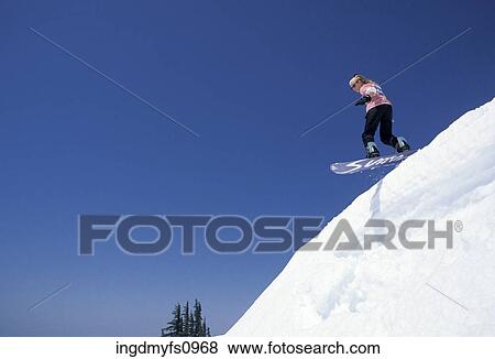 Woman Snowboarding Off a Steep Slope View Large Photo Image Stock Photo - Woman Snowboarding Off a Steep Slope. Fotosearch