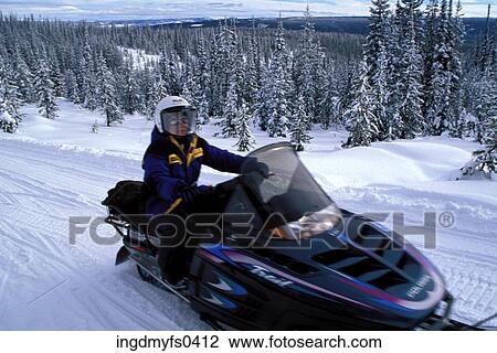 Stock Image - Woman Snowmobiling. Fotosearch