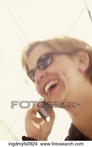 Woman Talking on a Cell Phone View Large Photo Image Picture - Woman Talking on a Cell Phone. Fotosearch