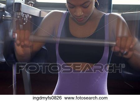 Woman Using Exercise Machine View Large Photo Image Stock Photograph - Woman Using Exercise Machine. Fotosearch