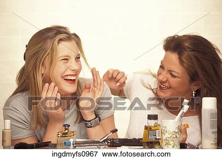 Women Laughing and Doing Their Makeup View Large Photo Image Stock Photo - Women Laughing and Doing Their Makeup. Fotosearch