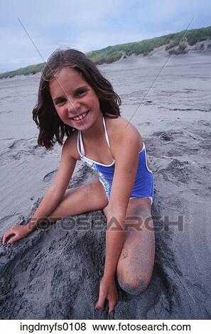 Stock Photo - Young Girl Playing in Sand. Fotosearch