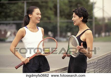 Young Women Playing Tennis Together View Large Photo Image Stock Image - Young Women Playing Tennis Together. Fotosearch