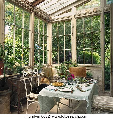 A dining table laid out in a greenhouse View Large Photo Image Stock Image - A dining table laid out in a greenhouse. Fotosearch