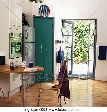 A modern kitchen with a door opening into the garden View Large Photo Image Stock Photo - A modern kitchen with a door opening into the garden. Fotosearch