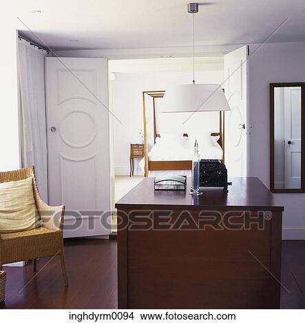 A wooden table in front of a bedroom View Large Photo Image Picture - A wooden table in front of a bedroom. Fotosearch