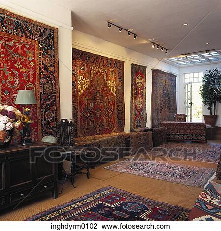 Carpets hung as tapestries on a wall in a room View Large Photo Image Stock Image - Carpets hung as tapestries on a wall in a room. Fotosearch