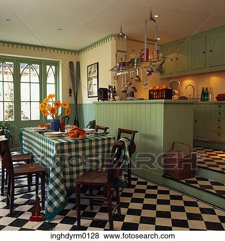 Checkered flooring in a kitchen with a dining area View Large Photo Image Stock Photo - Checkered flooring in a kitchen with a dining area. Fotosearch