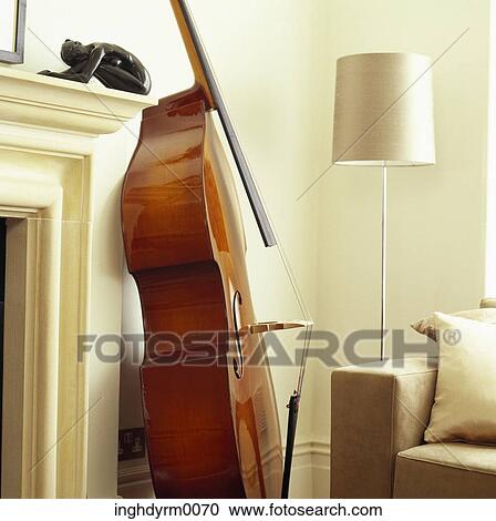 Close-up of a cello resting beside a fireplace in a living room View Large Photo Image Stock Image - Close-up of a cello resting beside a fireplace in a living room. Fotosearch