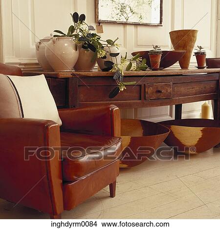 Close-up of a leather couch next to a wooden table View Large Photo Image Picture - Close-up of a leather couch next to a wooden table. Fotosearch
