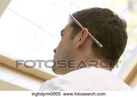 Close-up of a young man with a pencil behind his ear View Large Photo Image Stock Image - Close-up of a young man with a pencil behind his ear. Fotosearch