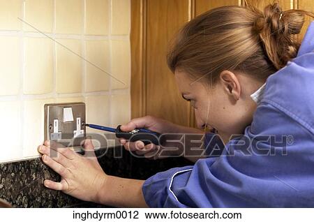 Close-up of a young woman opening an electric switch with a screwdriver View Large Photo Image Stock Image - Close-up of a young woman opening an electric switch with a screwdriver. Fotosearch