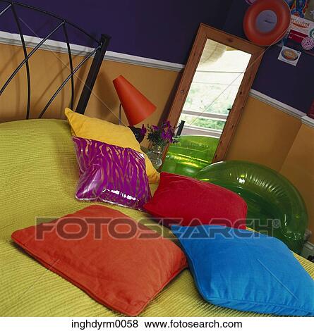 Stock Photo - Close-up of assorted cushions on a bed. Fotosearch