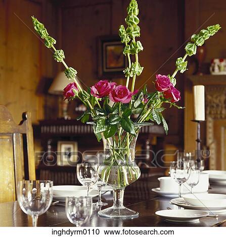 Close-up of roses in a glass vase on a dining table View Large Photo Image Stock Image - Close-up of roses in a glass vase on a dining table. Fotosearch