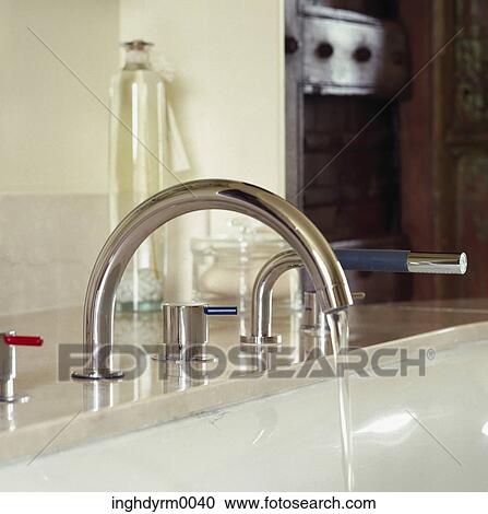 Stock Image - Close-up of water running from a tap on a sink. Fotosearch