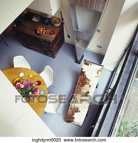 High angle view of a dining table on a balcony View Large Photo Image Stock Image - High angle view of a dining table on a balcony. Fotosearch