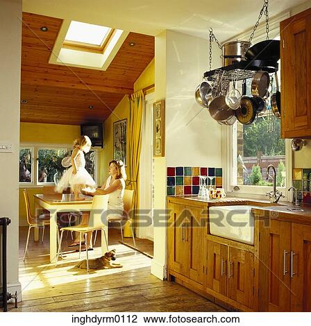 Stock Image - Mother dressing up her young daughter in a fairy costume. Fotosearch
