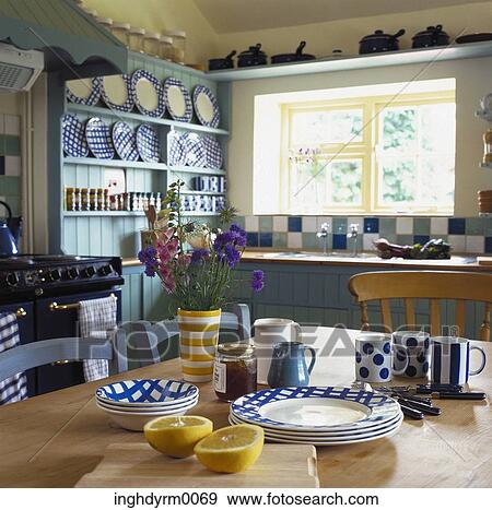 Stock Photo - Tableware displayed on a dining table inside a kitchen. Fotosearch