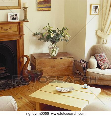Stock Photography - View of a coffee table in a living room with a fireplace. Fotosearch