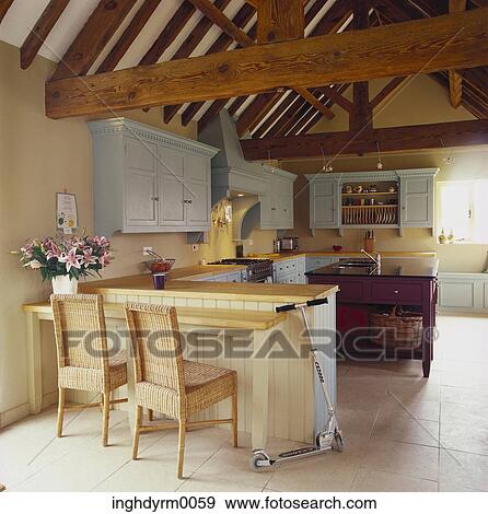 Stock Photo - View of a country style kitchen with wooden beams overhead. Fotosearch