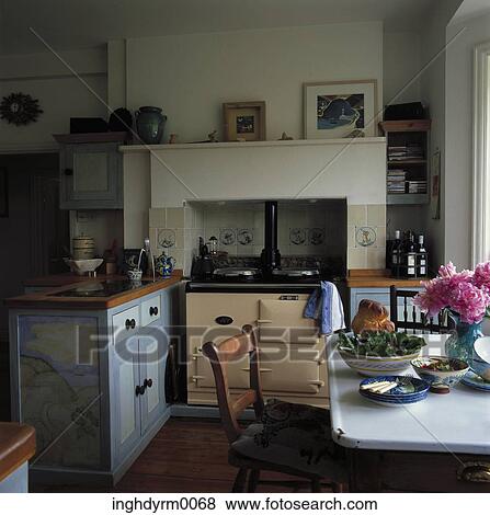 View of a dining table in a blue wood kitchen View Large Photo Image Stock Photo - View of a dining table in a blue wood kitchen. Fotosearch